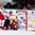MINSK, BELARUS - MAY 12: Switzerland's Denis Hollenstein #70 gets knocked into Belarus' Vitali Koval #1 by Roman Graborenko #92 while Oleg Yevenko #25 looks on during preliminary round action at the 2014 IIHF Ice Hockey World Championship. (Photo by Andre Ringuette/HHOF-IIHF Images)

